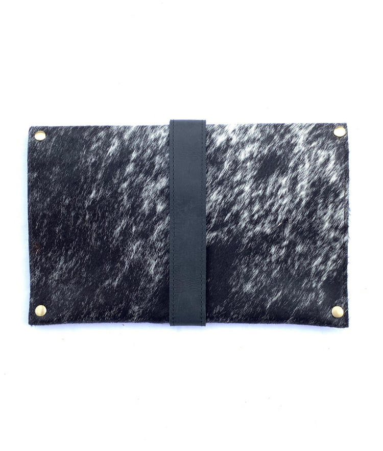 The back of RoHo's artisan made cowhide clutch with black and hair with black finished leather accents