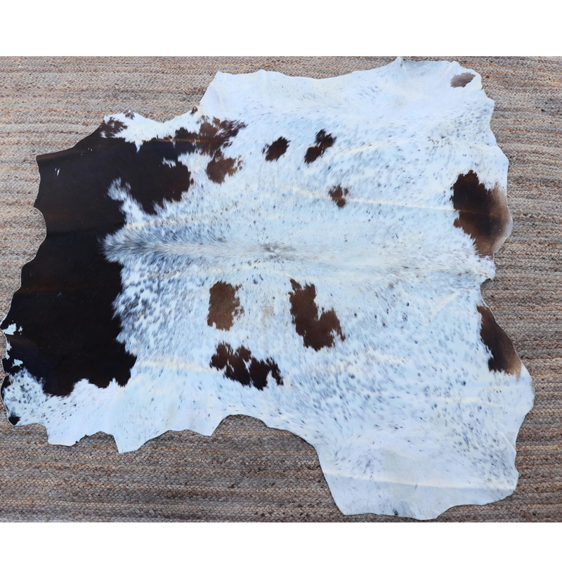 A brown and white RoHo cowhide rug that comes from Kenya