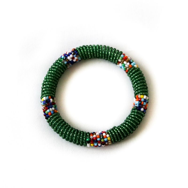 One handmade RoHo Fair Trade green beaded small bangle on a white background