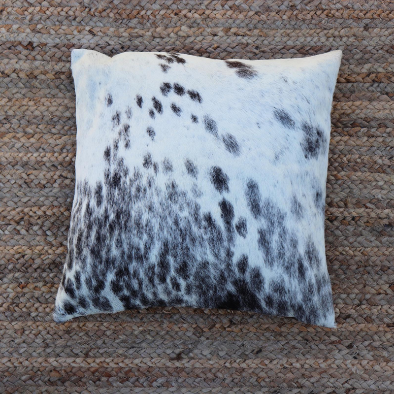 A handmade Kenyan cowhide RoHo accent pillow in black spots and white
