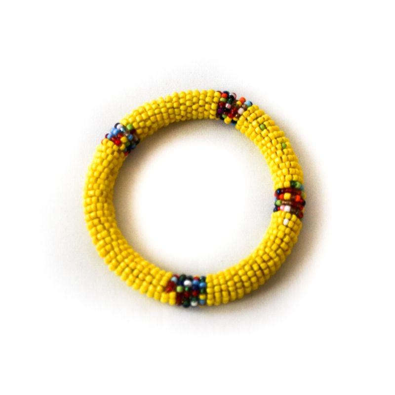 One single yellow Fair Trade RoHo beaded bangle bracelet against a white background