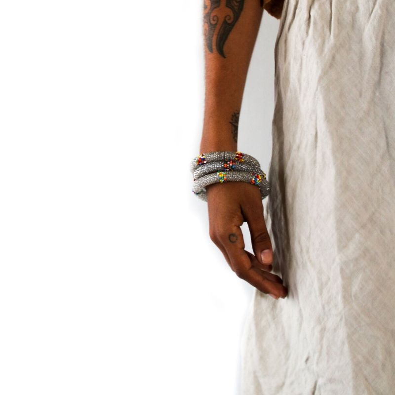 Three Fair Trade RoHo handmade silver beaded small bangles with multicolored accents  on a model