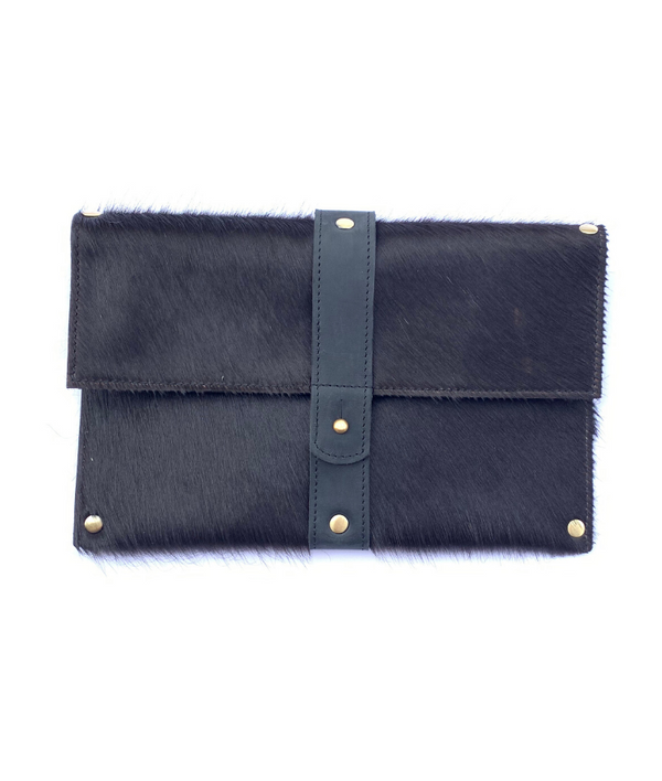 RoHo's Purposeful cowhide clutch in all black hair with black finished leather accents on a white background