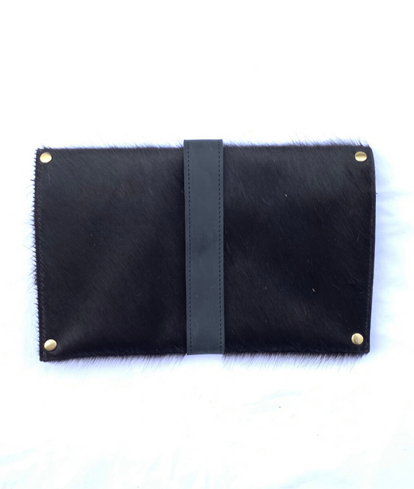 The Back of RoHo's artisan made cowhide clutch in all black hair with black finished leather accents