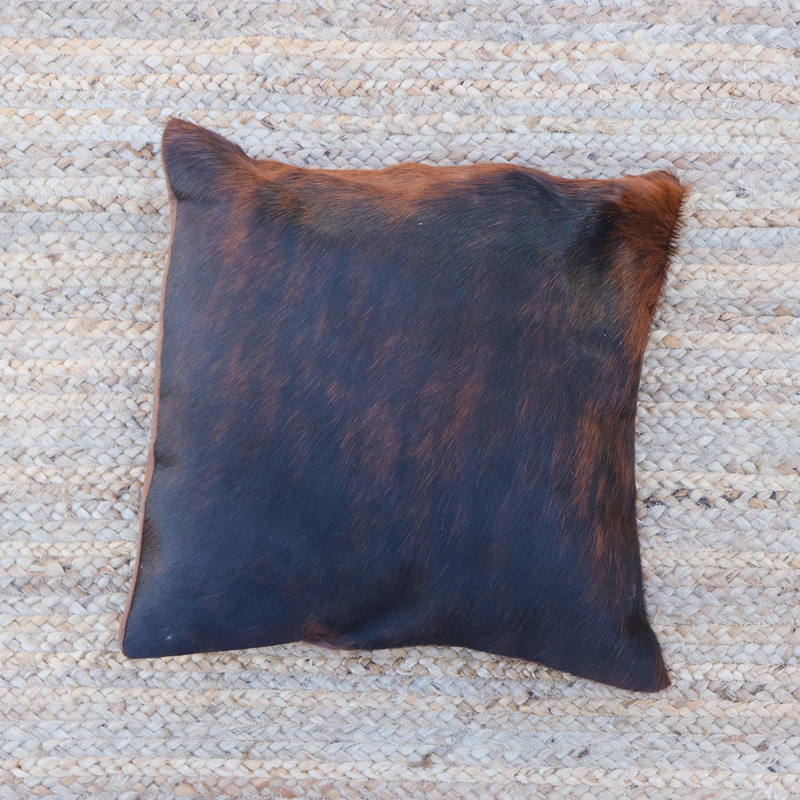 A brown and black brindle cowhide RoHo accent pillow handmade in Kenya