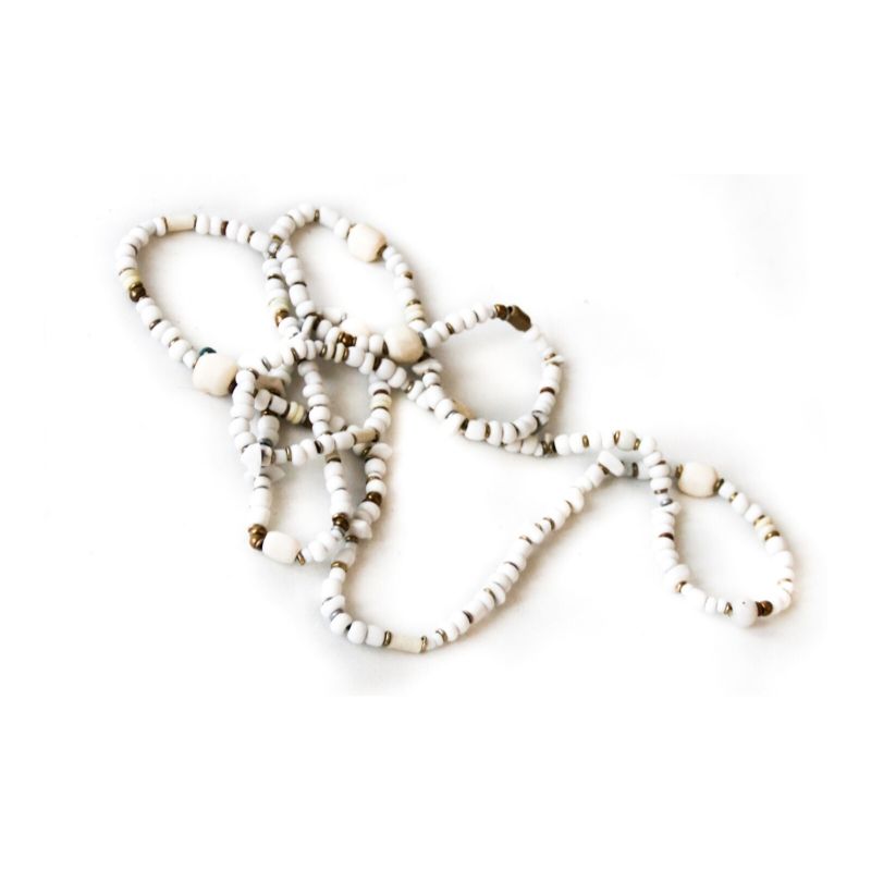 RoHo's Cow bone and glass necklace that make a difference, against a white background