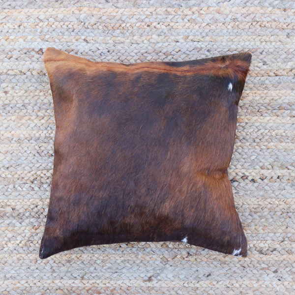 A brown and black brindle cowhide decorative RoHo pillow handmade in Kenya