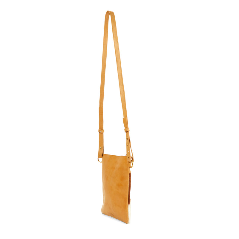 The back of RoHo's Handmade, Minimalist & Unique Tan & White Hair On Small Crossbody Pouch, Handcrafted in Kenya