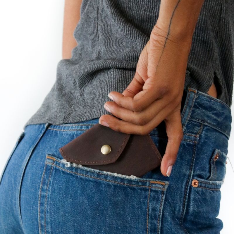 A handmade RoHo finished brown leather wallet that empowers artisans with dignified work on the pocket of a model