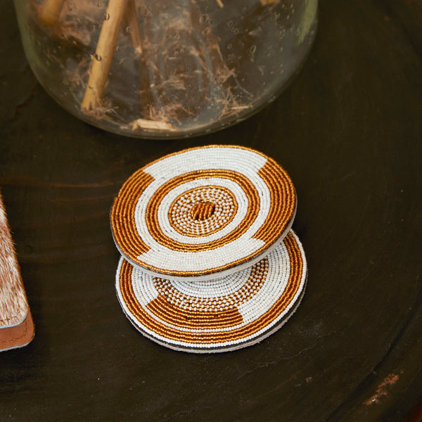 Close up of RoHo Fair Trade Handcrafted Maasai Gold & White Beaded Coasters, Handmade by Artisans in Kenya