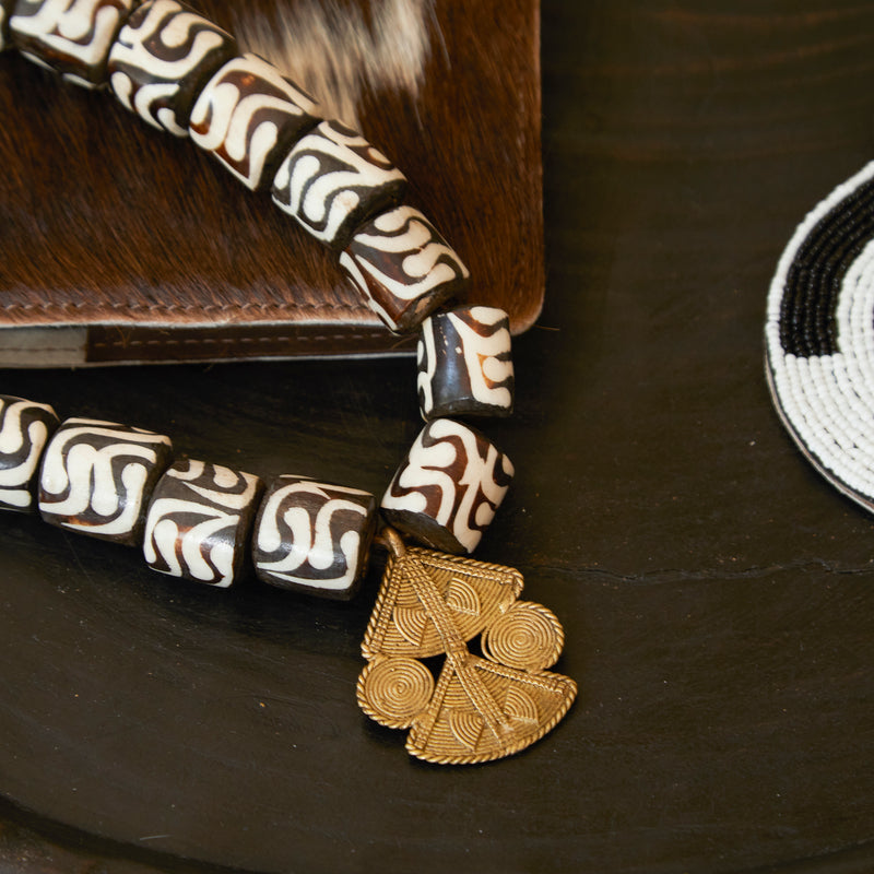 Close up of a RoHo Asili Batik Fair Trade Cow Bone Beads With Pendant