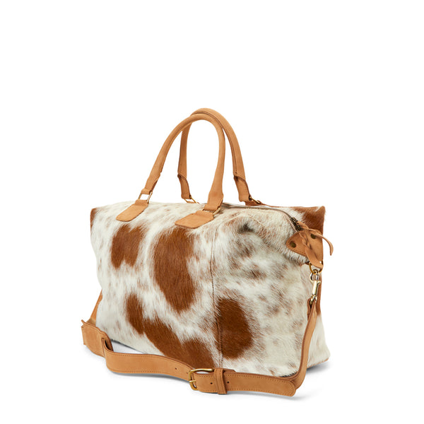 The side view of RoHo's Unique Tan & White Cowhide Weekender Bag